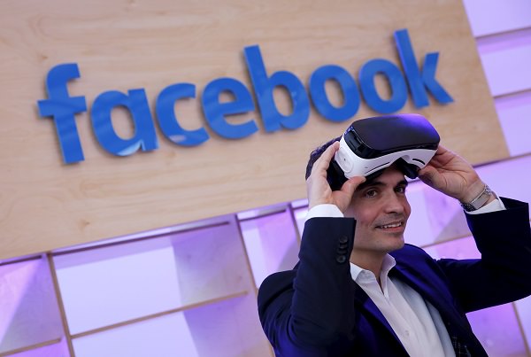 Facebook's Managing Director Northern, Central and Eastern Europe Ott poses for the photographer with a virtual reality headset at the new Facebook Innovation Hub during a preview media tour in Berlin